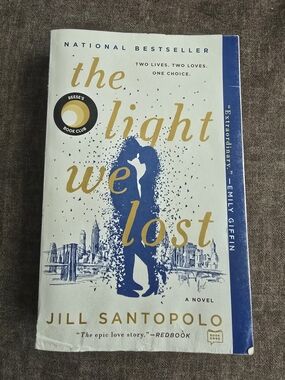 4/$12 The Light We Lost by Jill Santopolo - Blue & Gold Paperback